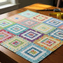 Colorful jelly roll quilt fabric strips arranged on a table, showcasing creativity in quilting